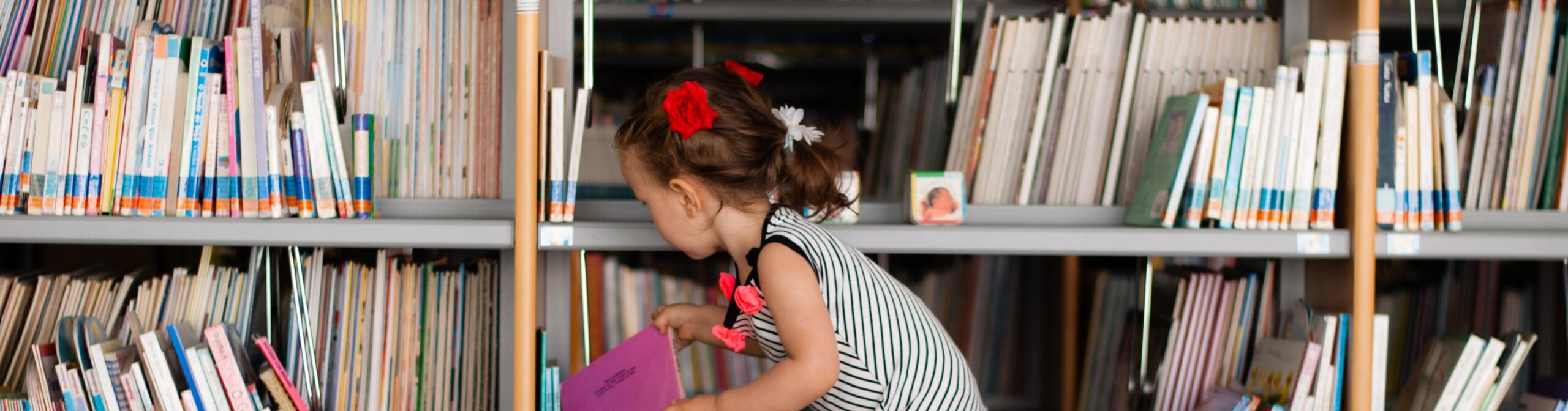 Little girl at a library stack