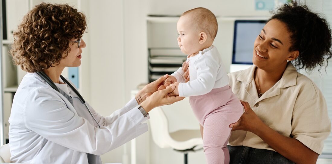 mother and baby with a doctor in an office