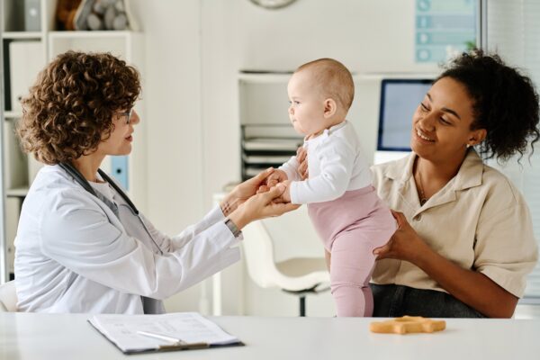 mother and baby with a doctor in an office