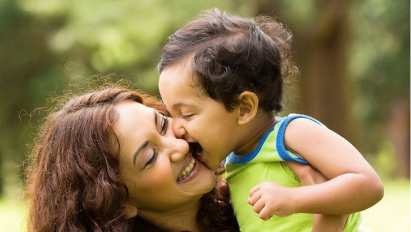 woman holding up a toddler