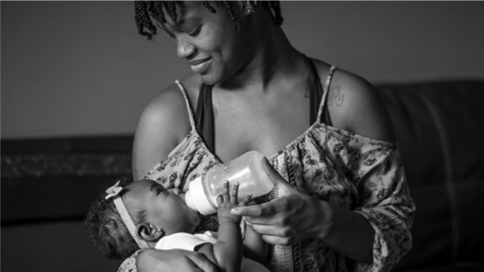 woman feeding a baby with a bottle