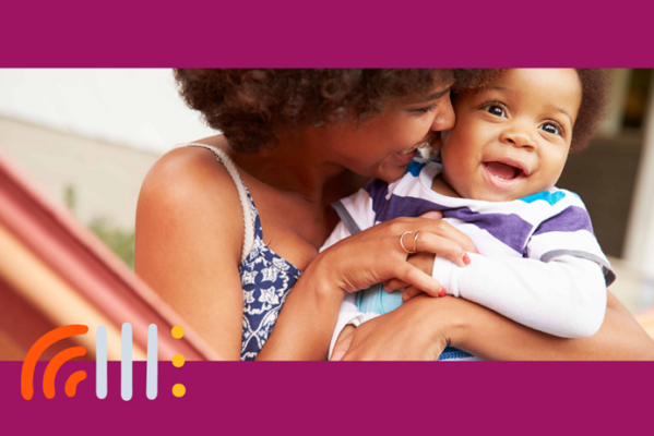 smiling woman holding toddler son