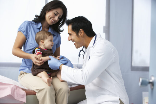 healthcare provider with woman and toddler in a pediatric office