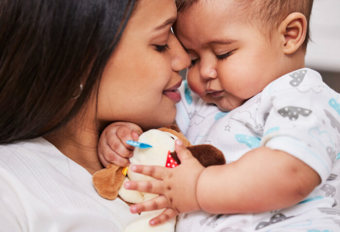 Woman holding baby in a nursery