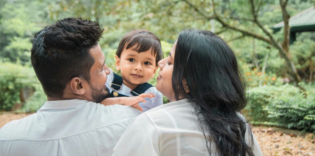 Mother and father holding a little boy