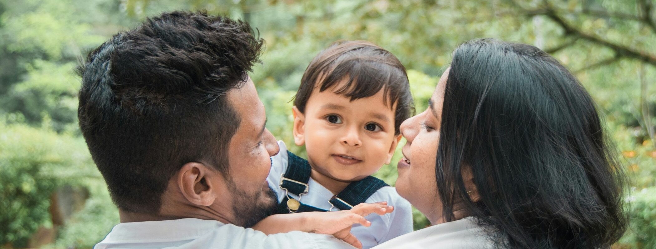 Mother and father holding a little boy