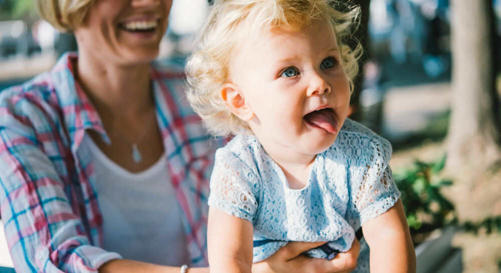 Toddler being held by mother